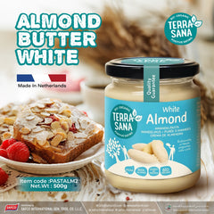 Jar of Terra Sana white almond butter with a slice of bread and berries on a table.