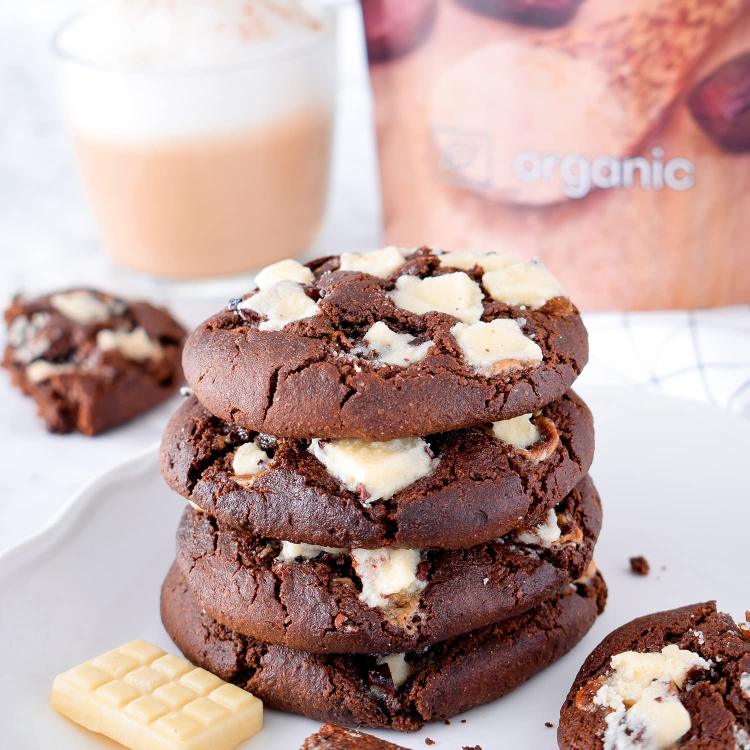 Stack of chocolate cookies with white chunks on a plate with a blurred background